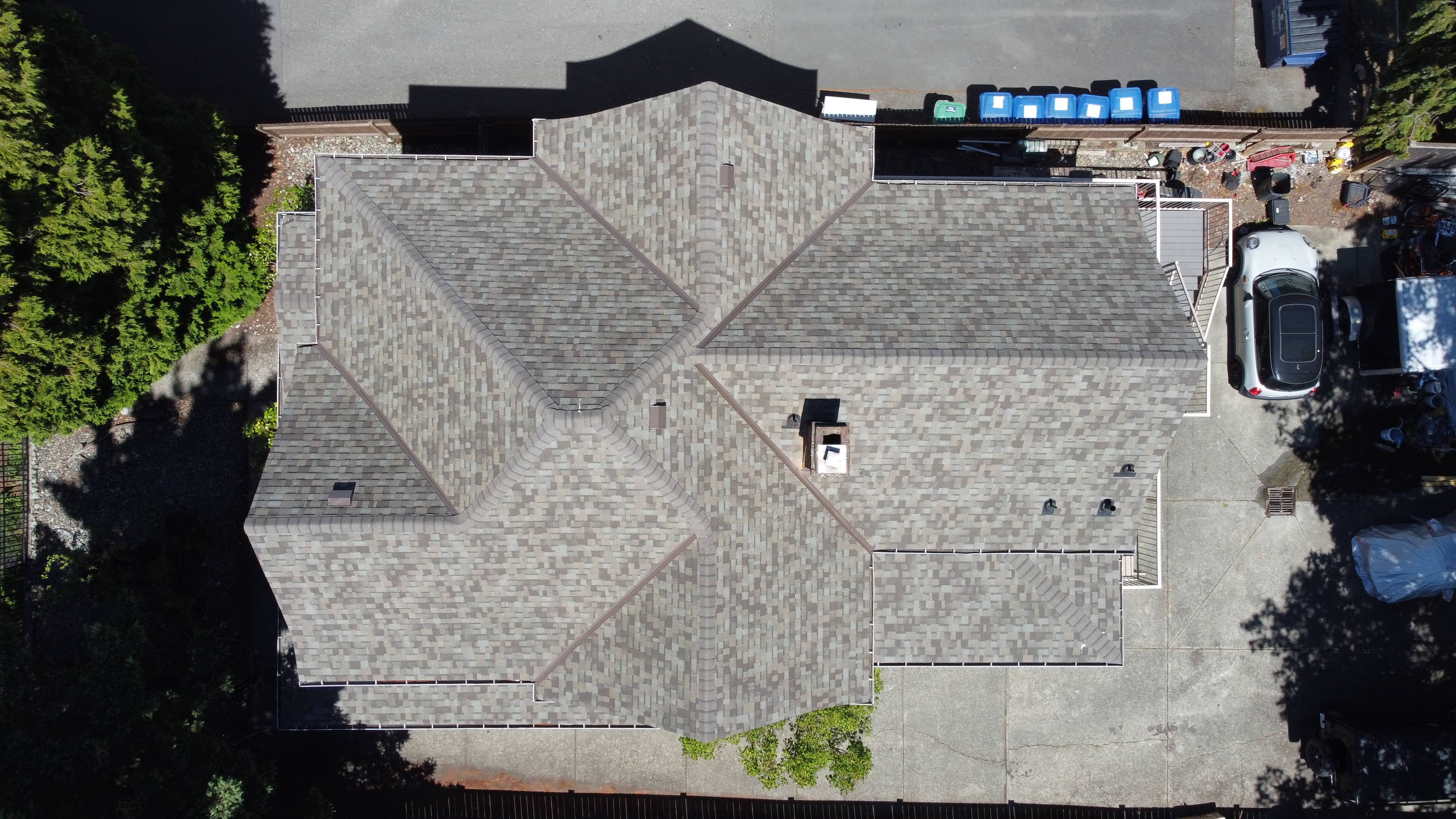 After - new driftwood asphalt shingle roof on large multi-gable home installed by McGuire Roofing