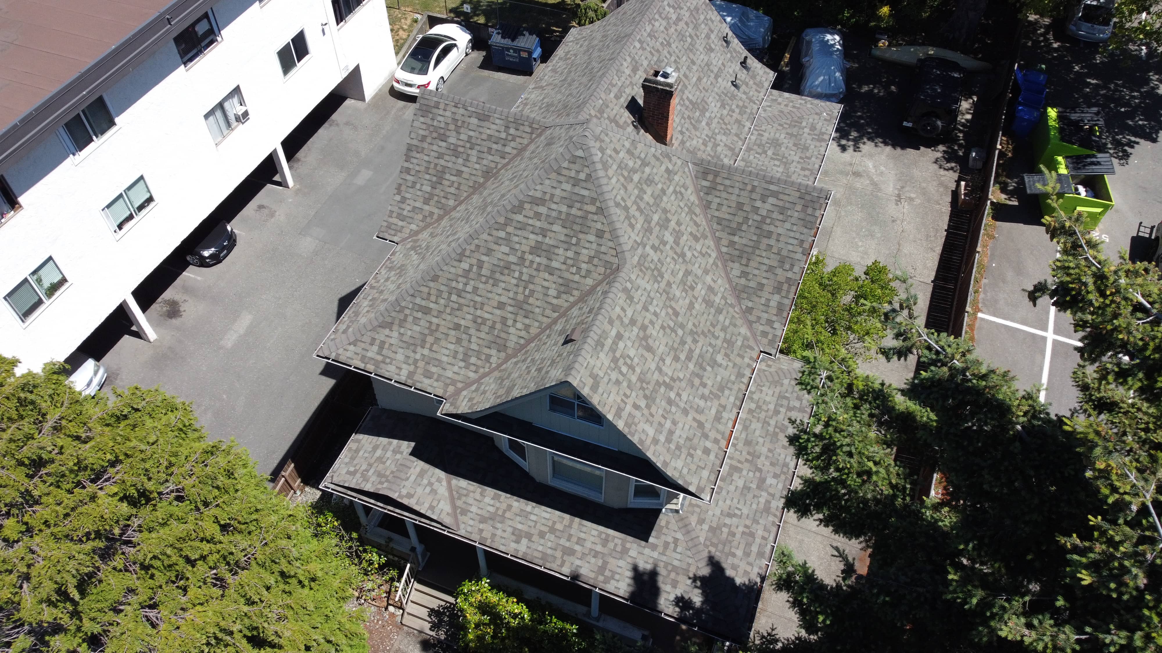 After - new grey asphalt shingle roof on character home installed by McGuire Roofing