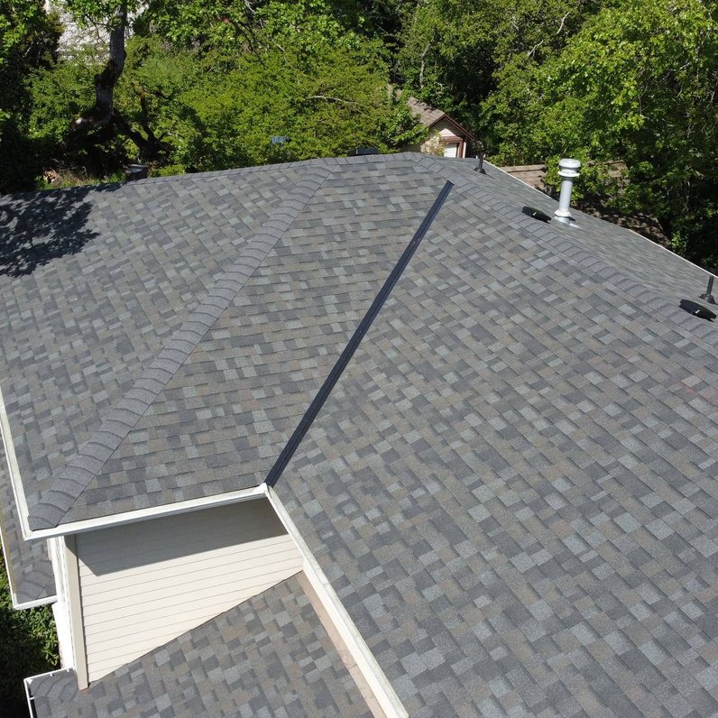 roofing crew installing asphalt shingles