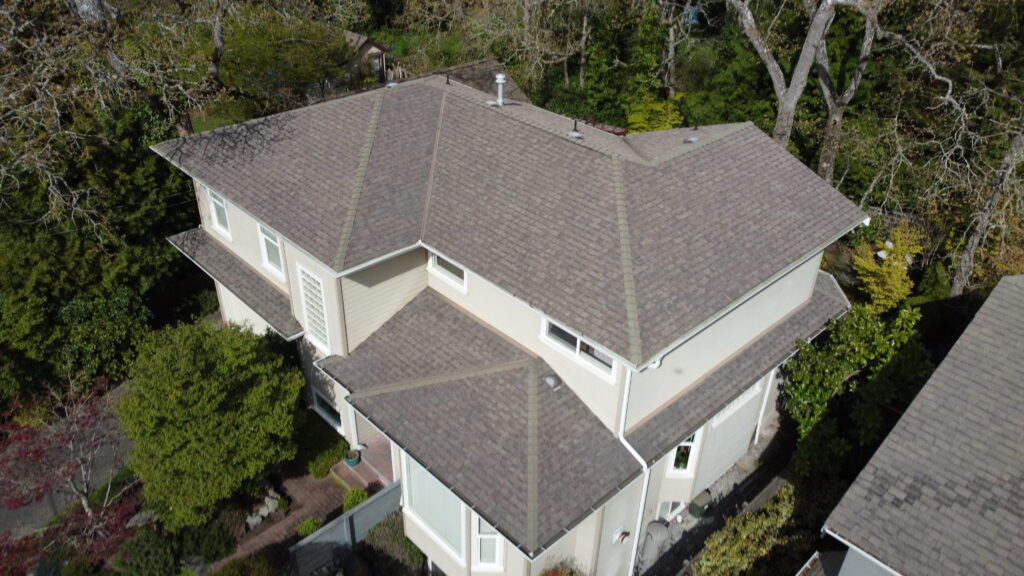 Aerial view of a residential house before re-roofing.